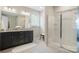 Bathroom featuring glass enclosed shower, dark vanity with granite top and white fixtures at 16112 Langston Dr, Charlotte, NC 28278