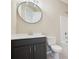 Bathroom with vanity, toilet, and framed round mirror at 16112 Langston Dr, Charlotte, NC 28278
