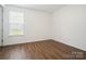 Bedroom with wood floor and window providing natural light at 16112 Langston Dr, Charlotte, NC 28278