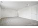 Spacious bedroom featuring neutral carpet, two closets, and access to natural light at 16112 Langston Dr, Charlotte, NC 28278