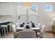 Elegant dining room featuring a stylish light fixture, natural light, and seating for six at 16112 Langston Dr, Charlotte, NC 28278