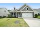 Attractive home featuring stone accents, gray siding, and a neatly kept front lawn at 16112 Langston Dr, Charlotte, NC 28278