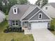Charming home featuring stone accents, gray siding, and a well-manicured front yard at 16112 Langston Dr, Charlotte, NC 28278