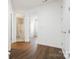 Hallway with two open doorways leading to rooms with white fixtures at 16112 Langston Dr, Charlotte, NC 28278