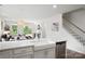 Bright kitchen featuring white cabinets, stainless steel appliances, and an open concept design flowing into the dining area at 16112 Langston Dr, Charlotte, NC 28278