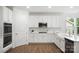 Well-lit kitchen featuring white cabinets, subway tile backsplash, and stainless steel appliances at 16112 Langston Dr, Charlotte, NC 28278