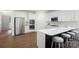 Open kitchen with white cabinets, stainless steel appliances, and a center island with seating at 16112 Langston Dr, Charlotte, NC 28278