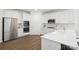 Spacious kitchen with white cabinetry, stainless steel appliances, and a breakfast bar area at 16112 Langston Dr, Charlotte, NC 28278