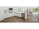 Modern kitchen with white cabinets, stainless steel appliances, and an eat-in counter at 16112 Langston Dr, Charlotte, NC 28278
