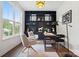 Bright living room featuring gray chairs, a large window, and a black bookcase with decor at 16112 Langston Dr, Charlotte, NC 28278