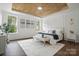 Serene main bedroom featuring a wood-paneled ceiling, three large windows, and elegant decor for a relaxing retreat at 16112 Langston Dr, Charlotte, NC 28278