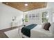 Bright main bedroom with wood ceiling, three windows, and white textured rug at 16112 Langston Dr, Charlotte, NC 28278