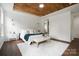 Comfortable main bedroom features a wood-paneled tray ceiling, neutral colors, and ample space for relaxation at 16112 Langston Dr, Charlotte, NC 28278