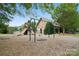 Fun playground with slides and swings next to the clubhouse, perfect for children to play at 16112 Langston Dr, Charlotte, NC 28278