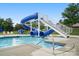 Community pool area featuring an exciting blue water slide and relaxing lounge area at 16112 Langston Dr, Charlotte, NC 28278