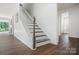 Staircase with carpeted treads and white risers leads to upper level at 16112 Langston Dr, Charlotte, NC 28278