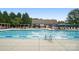 Community swimming pool with lane markers, chairs, tables, and lifeguard at 16112 Langston Dr, Charlotte, NC 28278