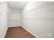 Walk-in closet with wood floor and wire shelving ready for ample storage at 16112 Langston Dr, Charlotte, NC 28278