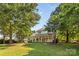 Expansive backyard with mature trees, a porch, and plenty of room for outdoor enjoyment and recreation at 1624 Moonstone Dr, Matthews, NC 28105