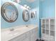 Updated bathroom with bright blue walls, double sink vanity, and storage at 1624 Moonstone Dr, Matthews, NC 28105