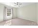 Cozy bedroom featuring neutral carpet, and a large window with coverings at 1624 Moonstone Dr, Matthews, NC 28105