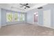 Light-filled bedroom with trey ceiling, neutral carpet, and large windows at 1624 Moonstone Dr, Matthews, NC 28105