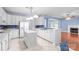 Bright white kitchen featuring an island, modern appliances, and a seamless flow into living area at 1624 Moonstone Dr, Matthews, NC 28105
