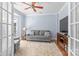 Cozy living room with ample natural light, ceiling fan, and neutral decor at 1624 Moonstone Dr, Matthews, NC 28105