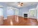 Open-concept living area with hardwood floors, a fireplace, and large windows for natural light at 1624 Moonstone Dr, Matthews, NC 28105