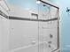Updated tiled shower with glass door and dark trim at 1624 Moonstone Dr, Matthews, NC 28105