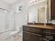 Well-appointed bathroom with a shower-tub combo, dark wood vanity, and neutral color scheme for a soothing ambiance at 172 Barber Loop, Mooresville, NC 28117