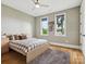 Comfortable bedroom with hardwood floors, natural light from two windows, and stylish decor for a relaxing atmosphere at 172 Barber Loop, Mooresville, NC 28117