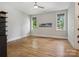 Bright bedroom showcasing hardwood floors, neutral walls, and two windows that flood the room with natural light at 172 Barber Loop, Mooresville, NC 28117