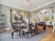 Elegant dining room with a modern glass table, leather chairs, and a decorative chandelier at 172 Barber Loop, Mooresville, NC 28117