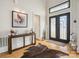 Bright foyer featuring hardwood floors, a modern console table, and a stylish double-door entrance at 172 Barber Loop, Mooresville, NC 28117
