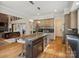 Elegant kitchen features an open layout, a wine cooler, and seamlessly connects to the living area at 172 Barber Loop, Mooresville, NC 28117
