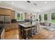 Open kitchen featuring a large island with bar seating, stainless steel appliances, and hardwood floors at 172 Barber Loop, Mooresville, NC 28117