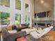 Spacious living room with a stone fireplace, high ceilings, and a comfortable seating arrangement at 172 Barber Loop, Mooresville, NC 28117