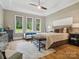 Spacious main bedroom with a tray ceiling, a sitting area, large windows, and hardwood floors at 172 Barber Loop, Mooresville, NC 28117