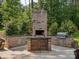 Well-equipped outdoor kitchen featuring a built-in grill, counter space, and seating for outdoor enjoyment at 172 Barber Loop, Mooresville, NC 28117