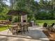 Outdoor kitchen and patio with dining table, grilling area, and outdoor fireplace, perfect for entertaining at 172 Barber Loop, Mooresville, NC 28117
