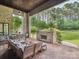 Covered patio with an outdoor fireplace, comfortable seating, and a dining area, perfect for outdoor entertaining at 172 Barber Loop, Mooresville, NC 28117
