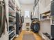 Well-organized walk-in closet with custom shelving, ample storage space, and hardwood floors at 172 Barber Loop, Mooresville, NC 28117