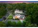 Beautiful aerial view of a two-story brick home with mature trees and a well-manicured lawn in a desirable neighborhood at 2100 Chesterfield Ave, Charlotte, NC 28205