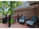 A deck with relaxing seating overlooks the landscaped backyard at 2100 Chesterfield Ave, Charlotte, NC 28205