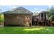 Expansive backyard showcasing the brick exterior of the home with a wooden deck and patio area at 2100 Chesterfield Ave, Charlotte, NC 28205