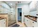 The stylish bathroom features a glass shower, light blue walls, and dark countertops at 2100 Chesterfield Ave, Charlotte, NC 28205
