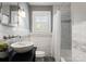 Bathroom with gray walls, marble countertops, modern sink and shower tub at 2100 Chesterfield Ave, Charlotte, NC 28205