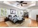 Large main bedroom with hardwood floors, tray ceiling, modern furniture and ample natural light at 2100 Chesterfield Ave, Charlotte, NC 28205
