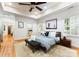 Beautiful bedroom featuring hardwood floors, tray ceilings, a ceiling fan, and ensuite bathroom at 2100 Chesterfield Ave, Charlotte, NC 28205